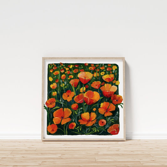 Framed artwork of orange flowers on a white wall