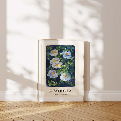 Framed artwork of flowers with 'Georgia' text on a wall.