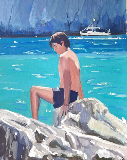 Painting of a boy sitting on rocks by a body of water with art supplies in the background.