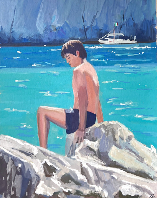 Painting of a boy sitting on rocks by a body of water with art supplies in the background.