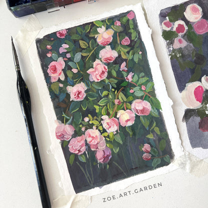 Floral art piece with watercolor set and brush on a white surface