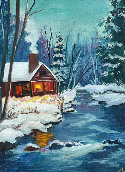 Winter landscape painting with watercolor set and brushes on a wooden surface, featuring the artist's signature 'Zoe Art Garden'.