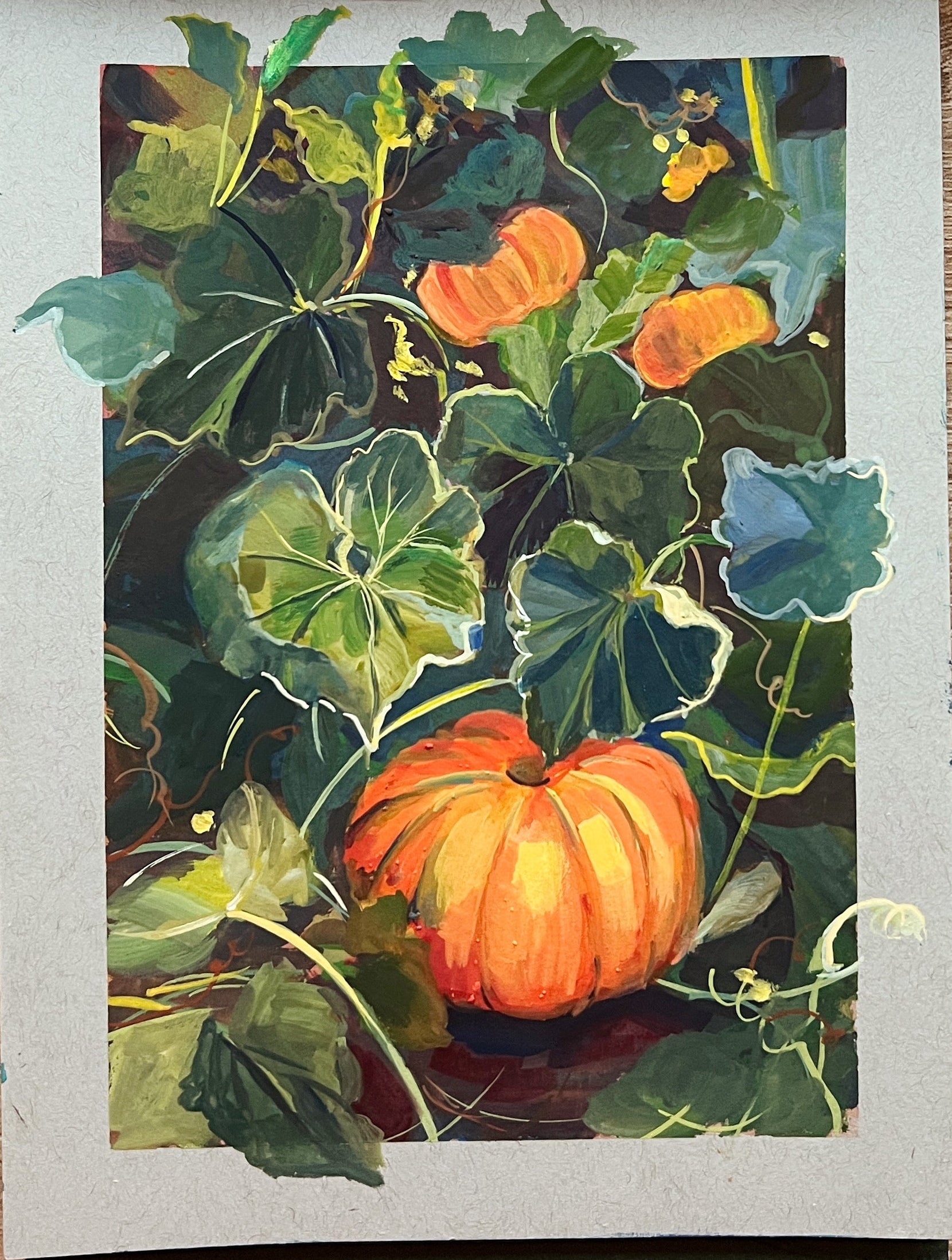 Artistic depiction of pumpkins and leaves with watercolor paints and a brush on a wooden surface.