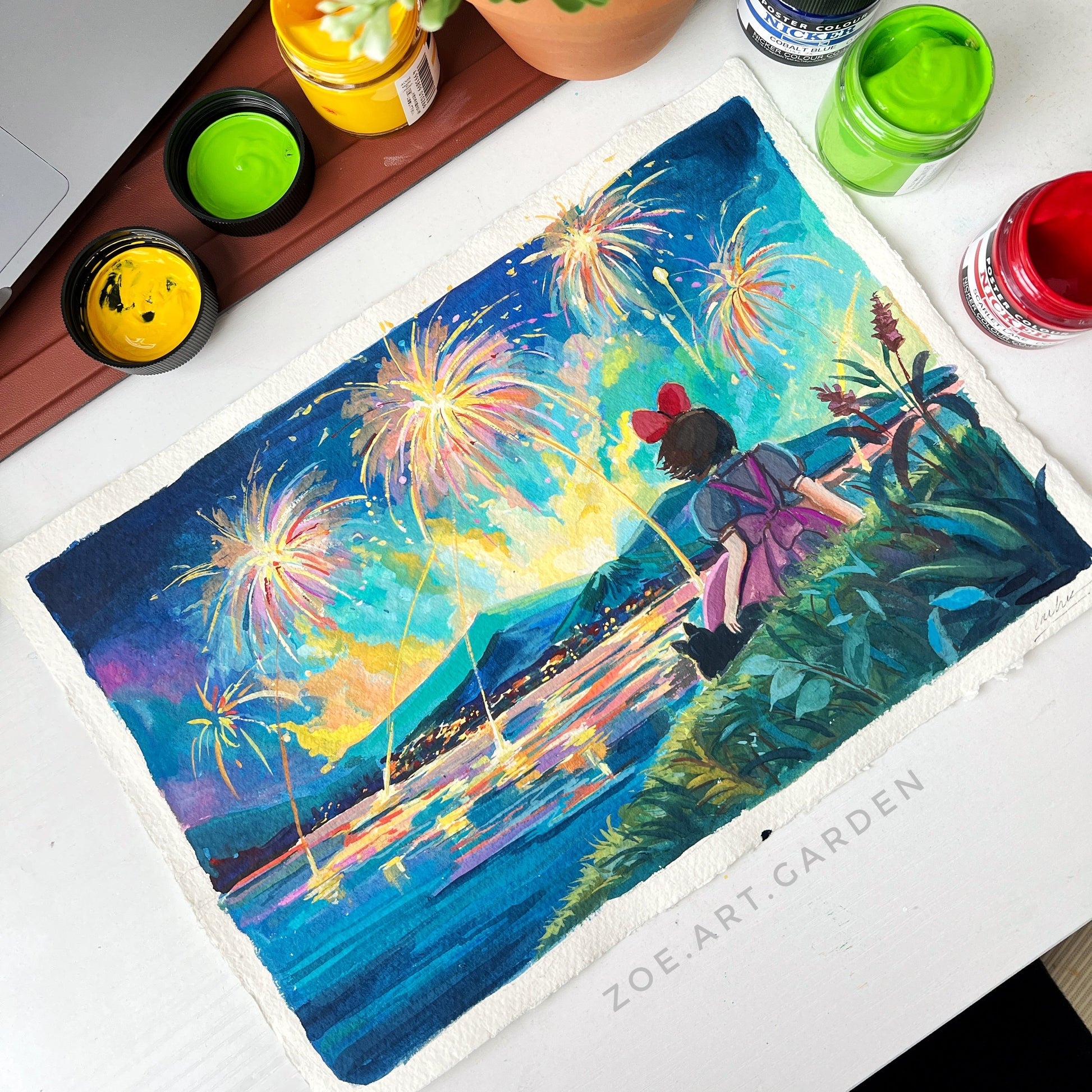 Colorful artwork of a woman on a swing with fireworks, surrounded by art supplies on a desk.