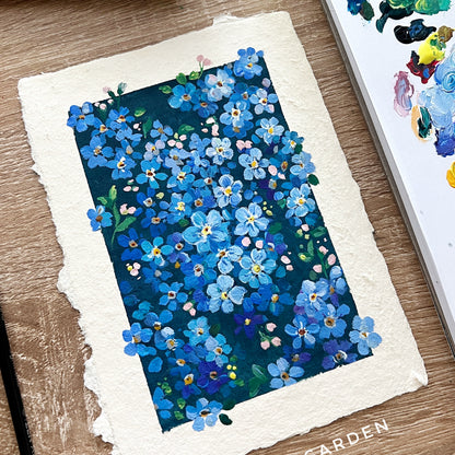 Artistic depiction of blue flowers on a textured paper with 'Zoe Art Garden' branding.