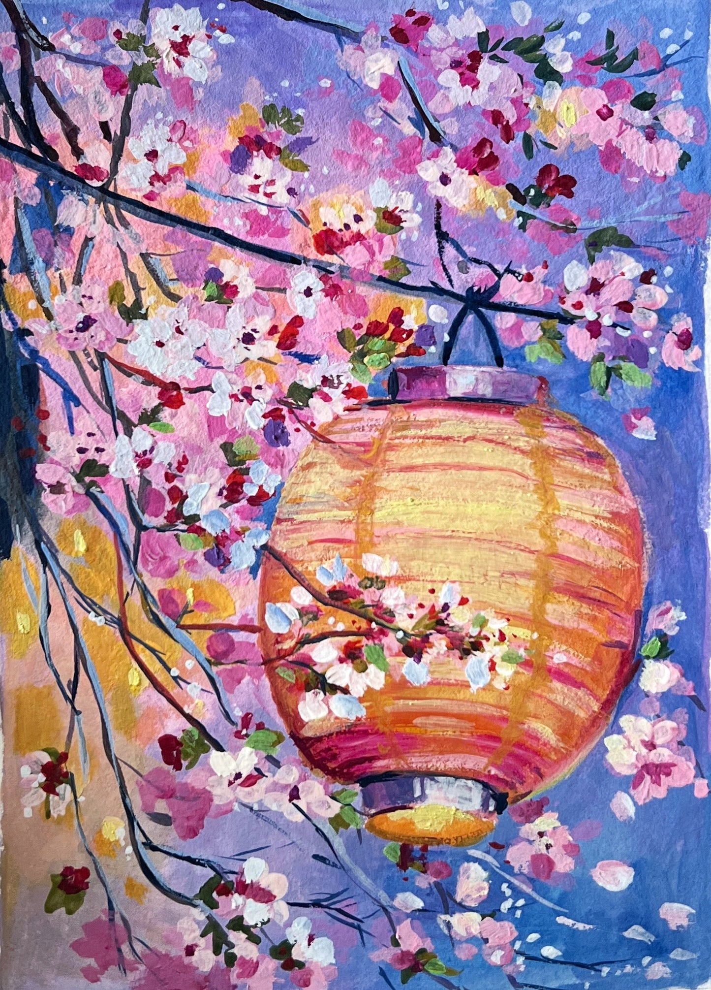 Hand holding a small painting of cherry blossoms and a lantern