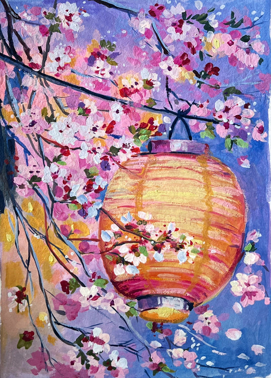 Hand holding a small painting of cherry blossoms and a lantern