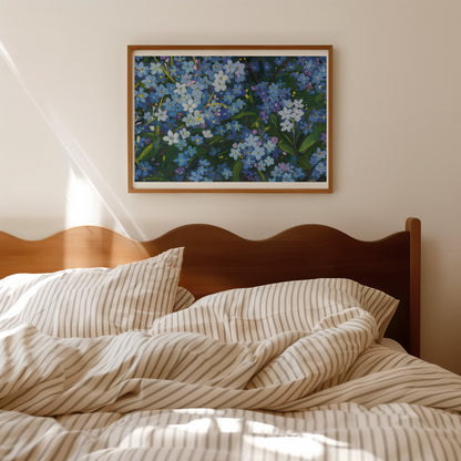 A framed floral painting hangs on a beige wall above a wooden bed with cream and tan striped bedding, in a softly lit bedroom.