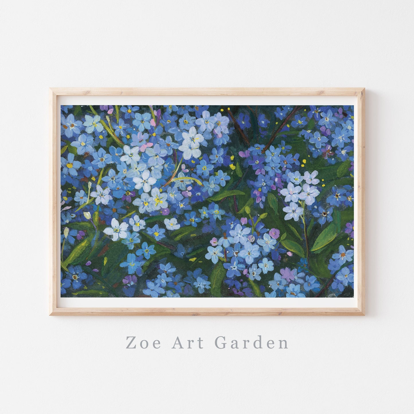 A framed floral art print featuring blue forget-me-nots with green leaves, displayed on a white wall with the text 'Zoe Art Garden' below the frame.