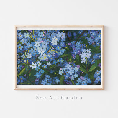 A framed floral art print featuring blue forget-me-nots with green leaves, displayed on a white wall with the text 'Zoe Art Garden' below the frame.