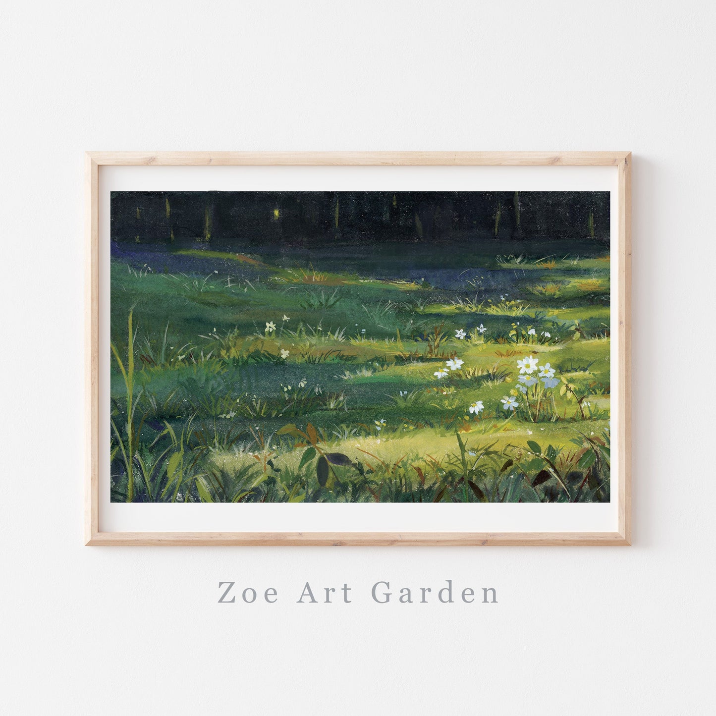 A framed landscape art print depicting a sunlit green meadow with wildflowers under a dark forest canopy, displayed on a white wall with the text 'Zoe Art Garden' below the frame.