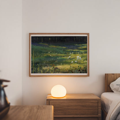 A framed landscape painting of a grassy field at night with glowing fireflies, displayed on a bedroom wall above a wooden nightstand with a glowing lamp.