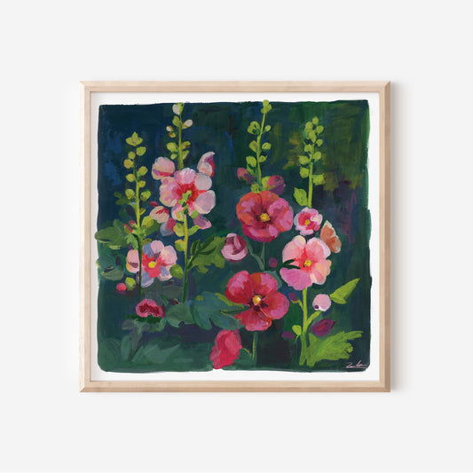 A framed painting of pink and red flowers with green stems on a dark background, displayed on a light gray wall.