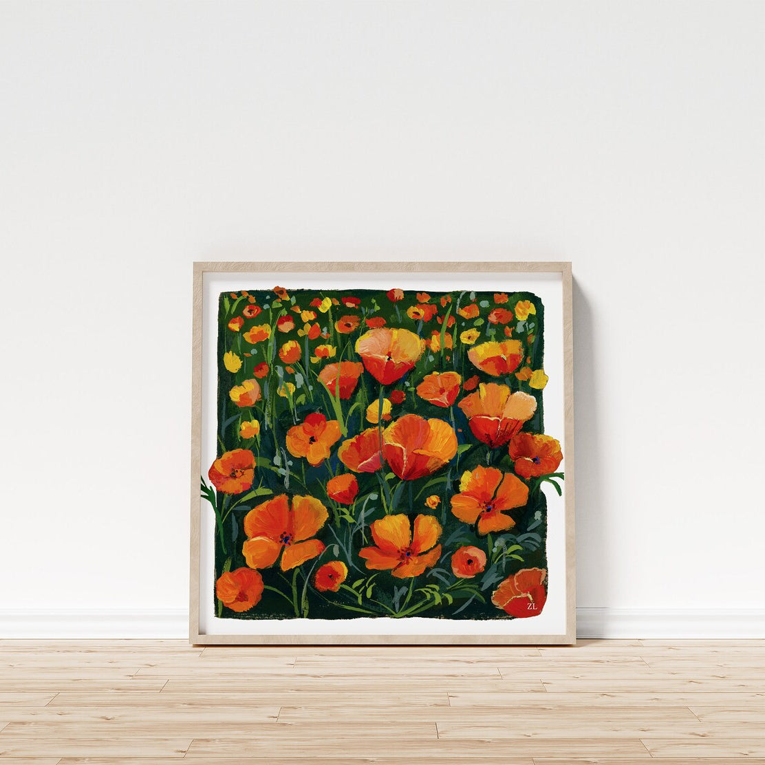 Framed artwork of orange flowers on a white wall