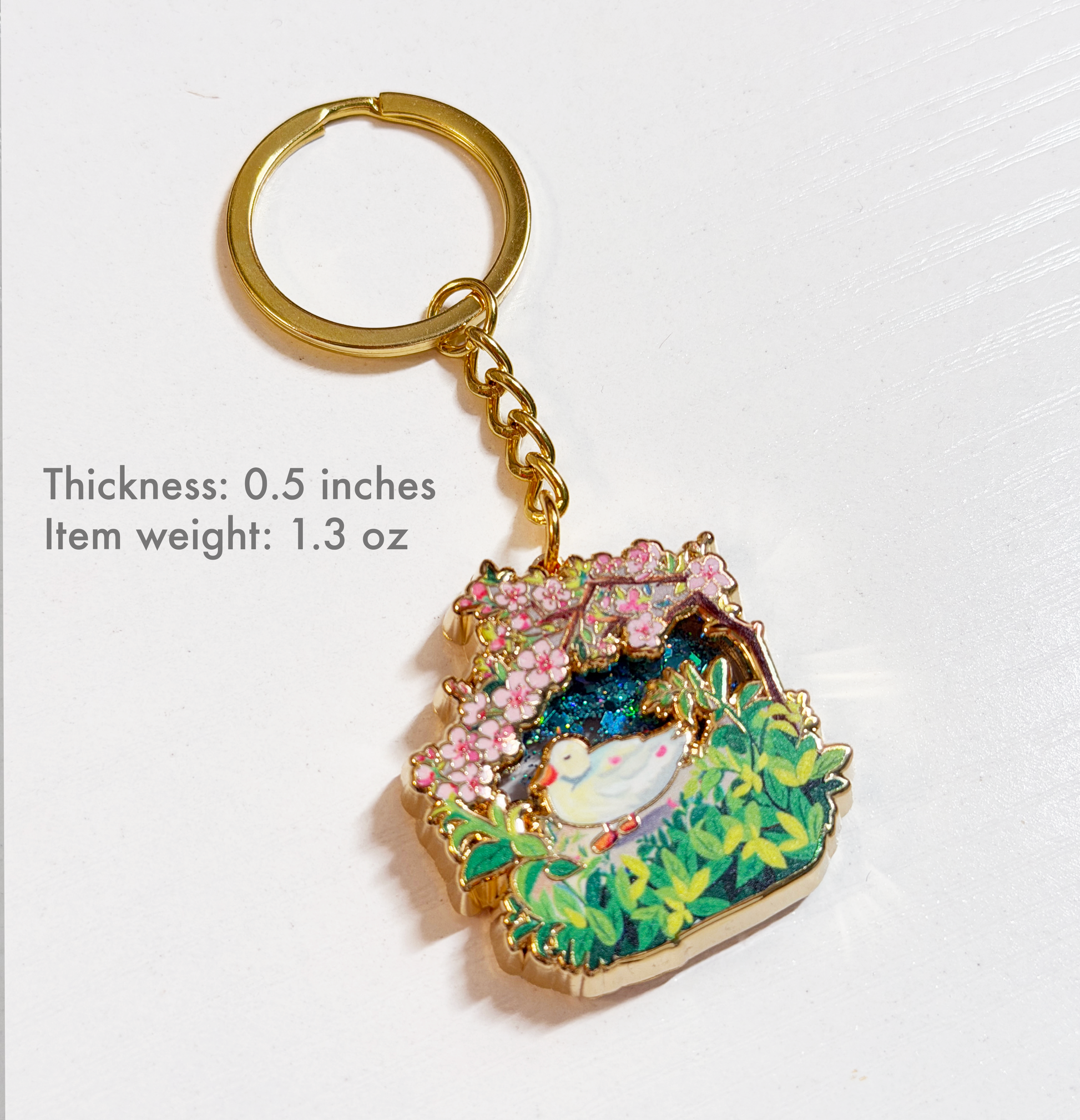 Decorative keychain with floral design on a white background