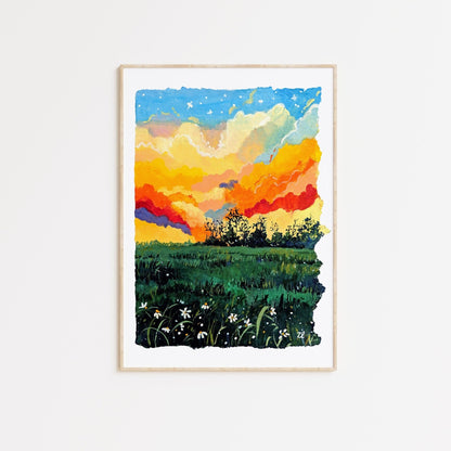 Framed artwork of a colorful sunset over a field with trees.