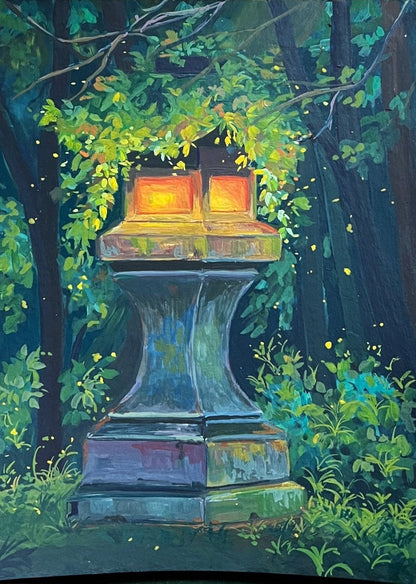 A photo of a gouache painting depicting a mossy Japanese lantern surrounded by greenery. The painting is accompanied by art supplies such as brushes and a palette, placed on a wooden surface.