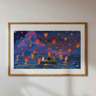 Framed artwork of a scene with colorful lanterns floating in the sky over water.