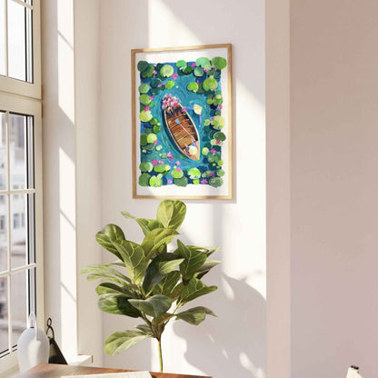 Framed artwork of a boat on water with lily pads on a white wall