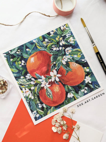 Framed artwork of oranges and flowers on a white background