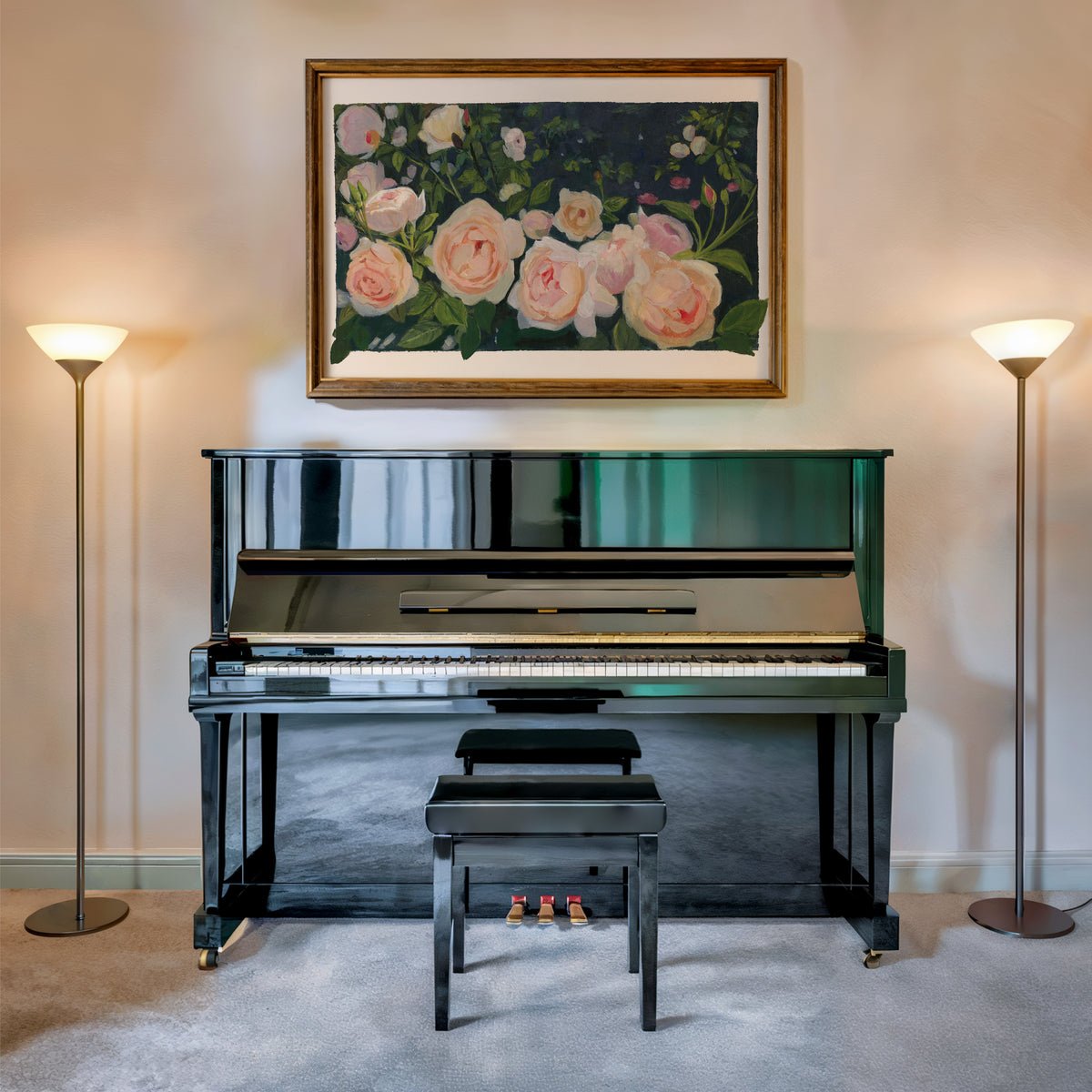 A glossy black upright piano with a matching bench, set in a room with two floor lamps and a framed floral painting on the wall above.